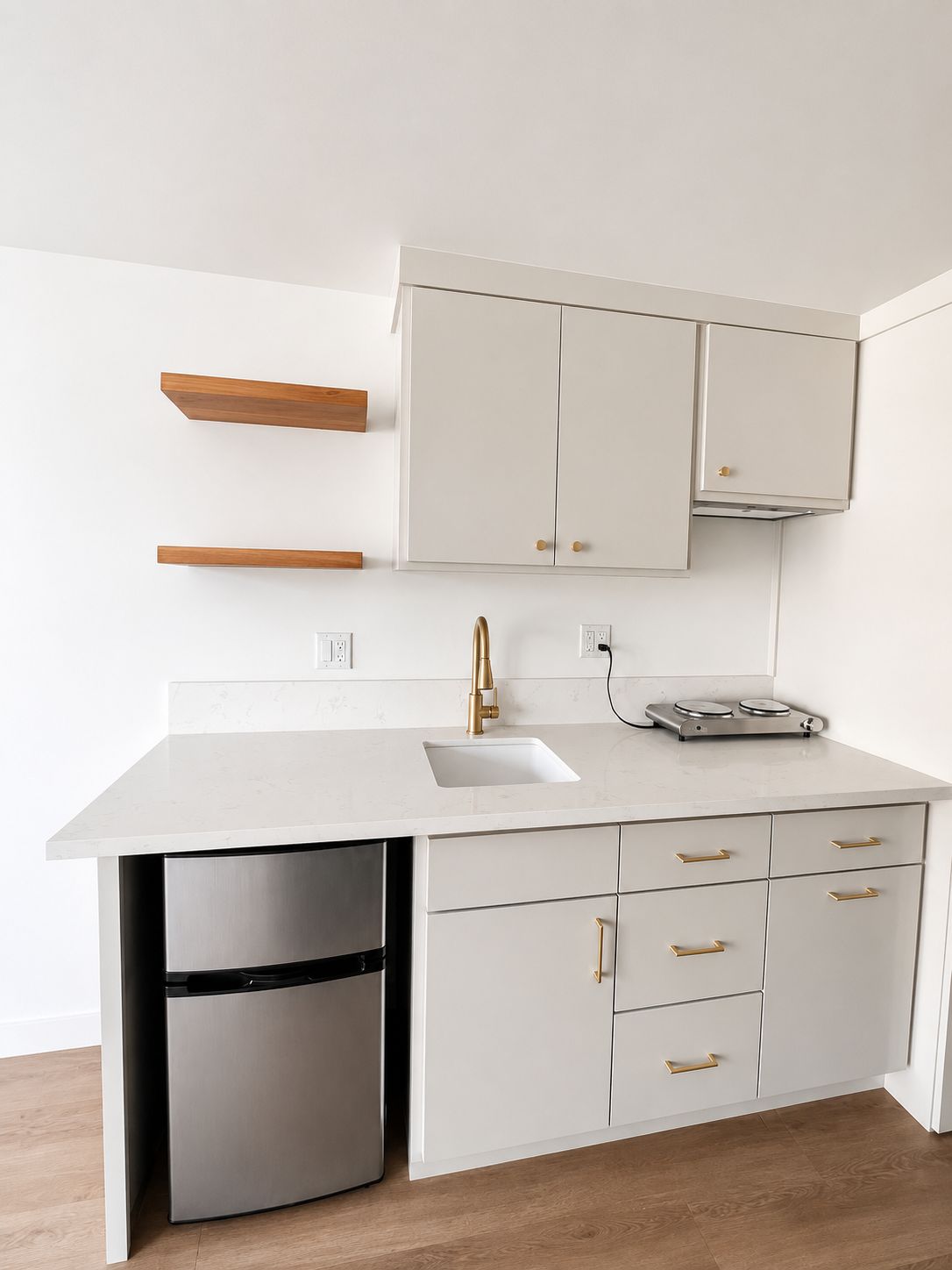Finished kitchen with white cabinetry and gold hardware