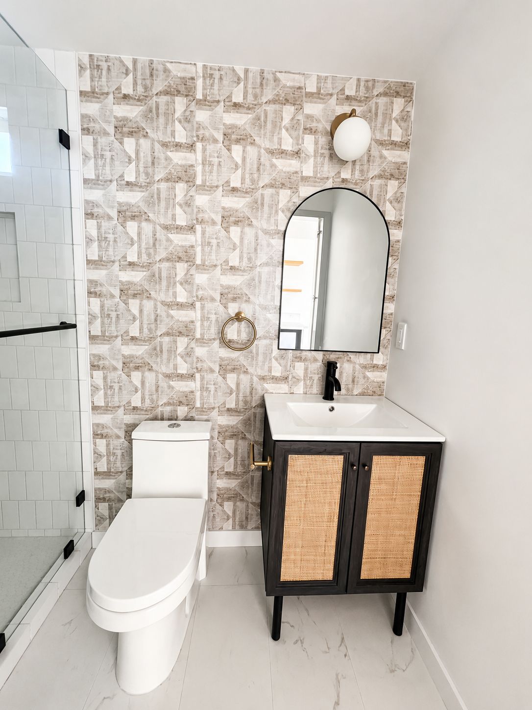 Bathroom vanity with patterned wallpaper accent wall