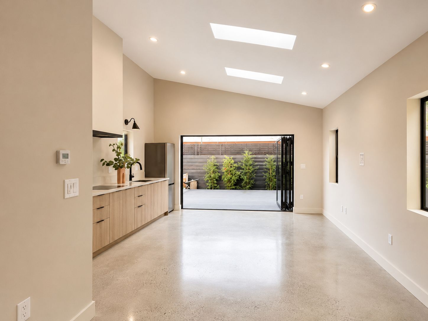 Open kitchen with wood cabinetry and view to the backyard