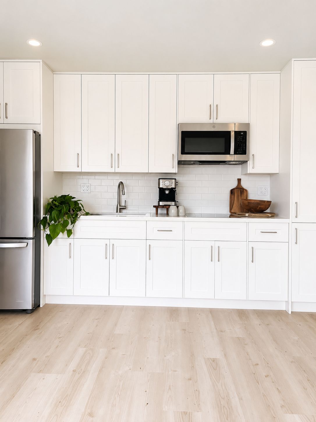 Kitchen wall with subway tile backsplash and built-in microwave