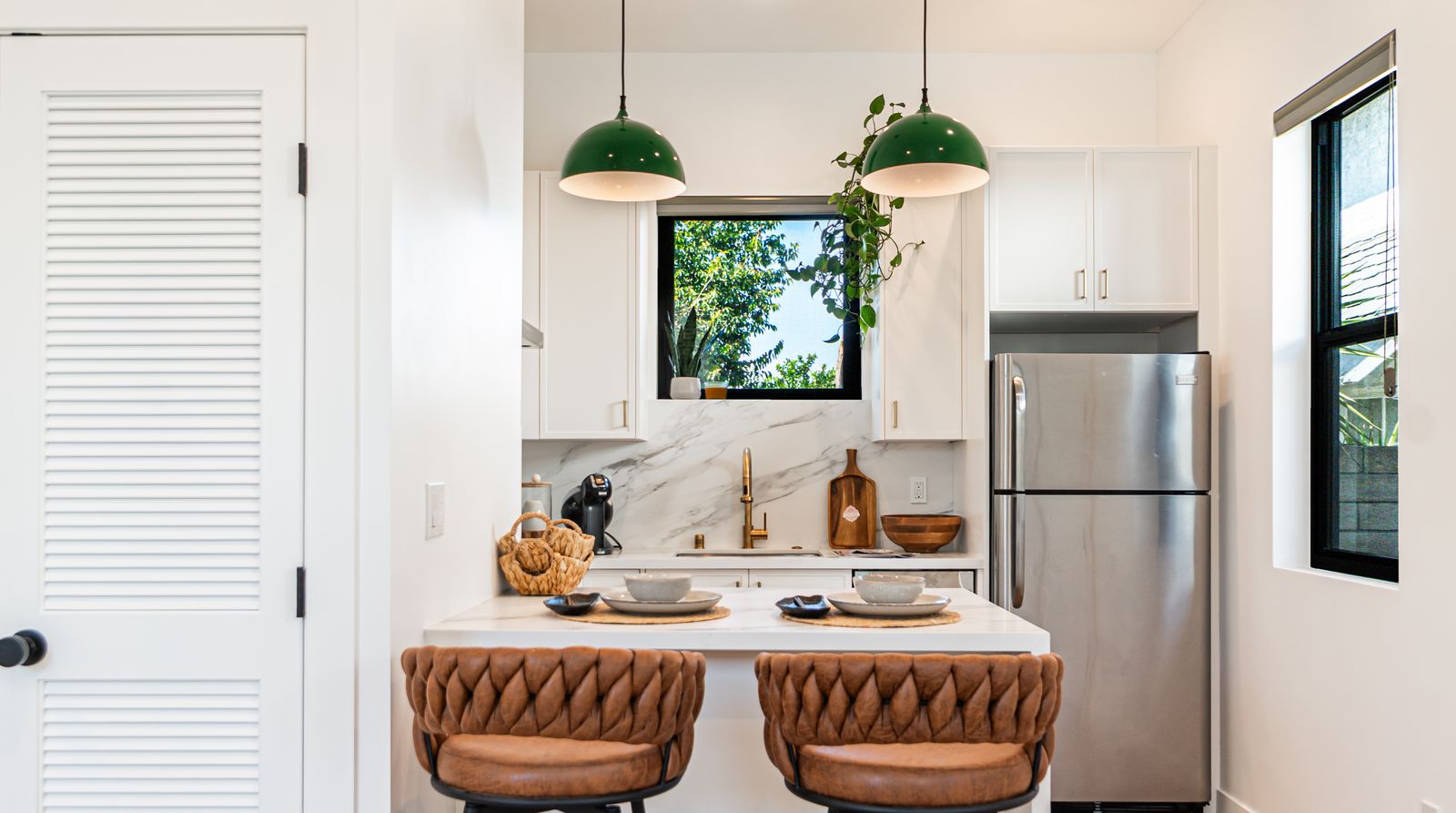Kitchen island with marble countertop and pendant lighting