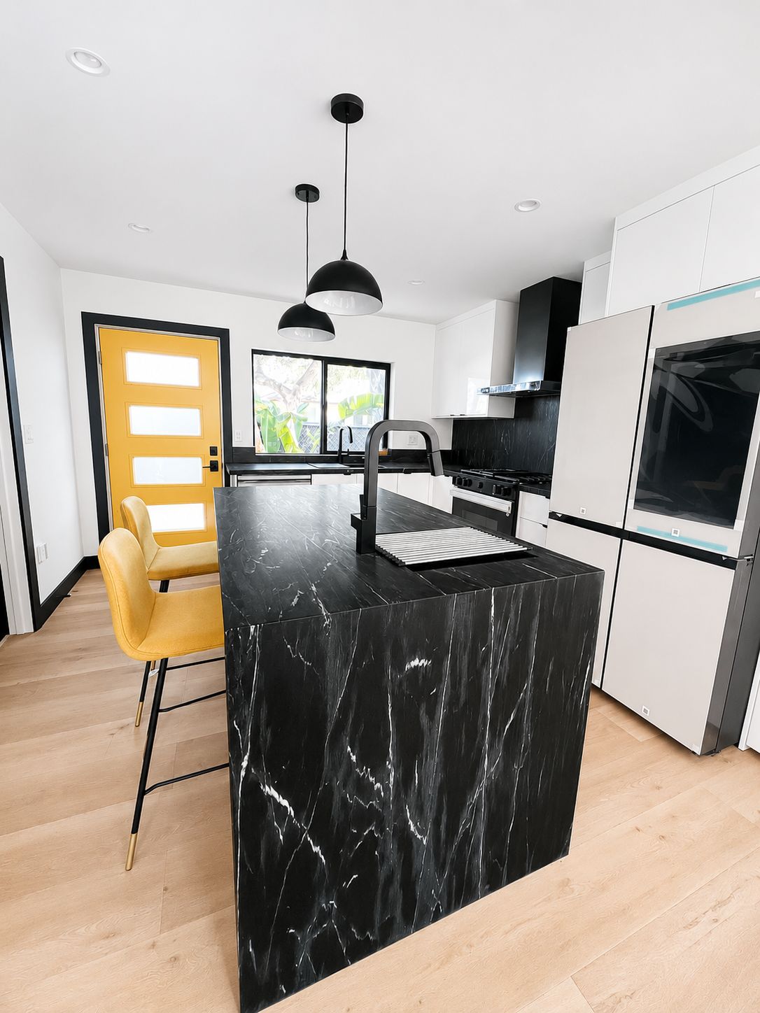 Kitchen island with black marble waterfall countertop