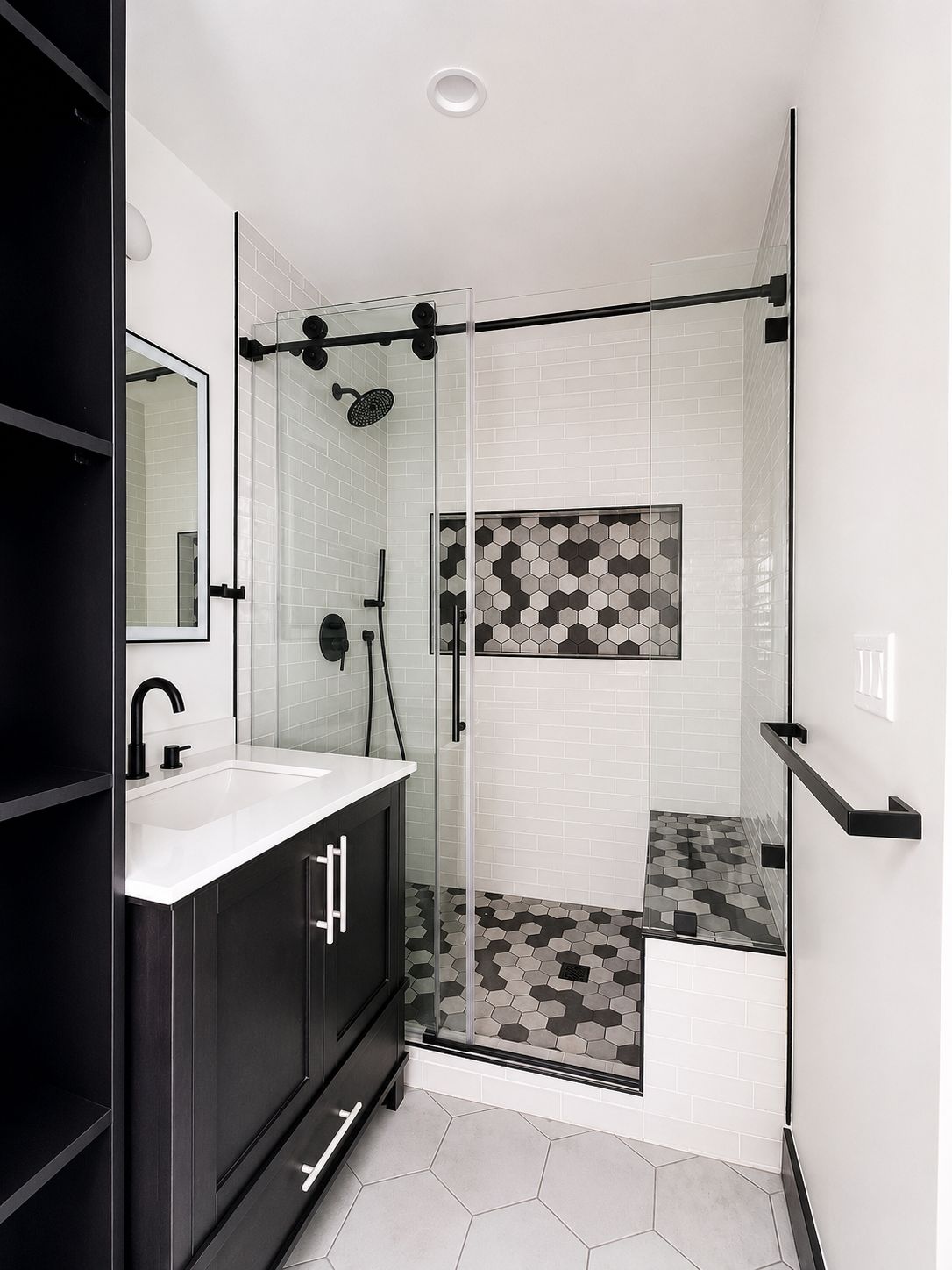 Bathroom shower with black and white hexagon tile