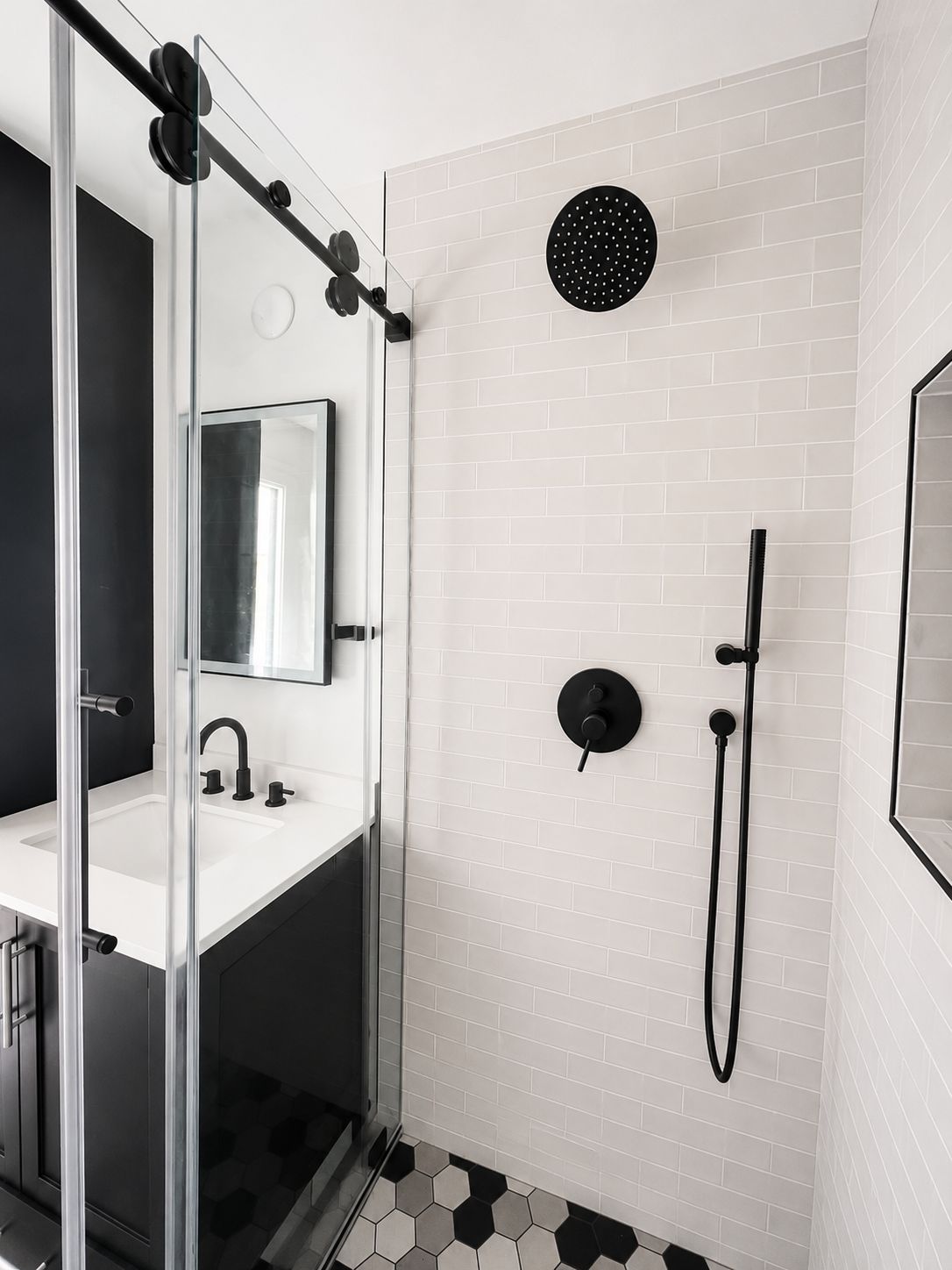 Bathroom shower with black fixtures and subway tile