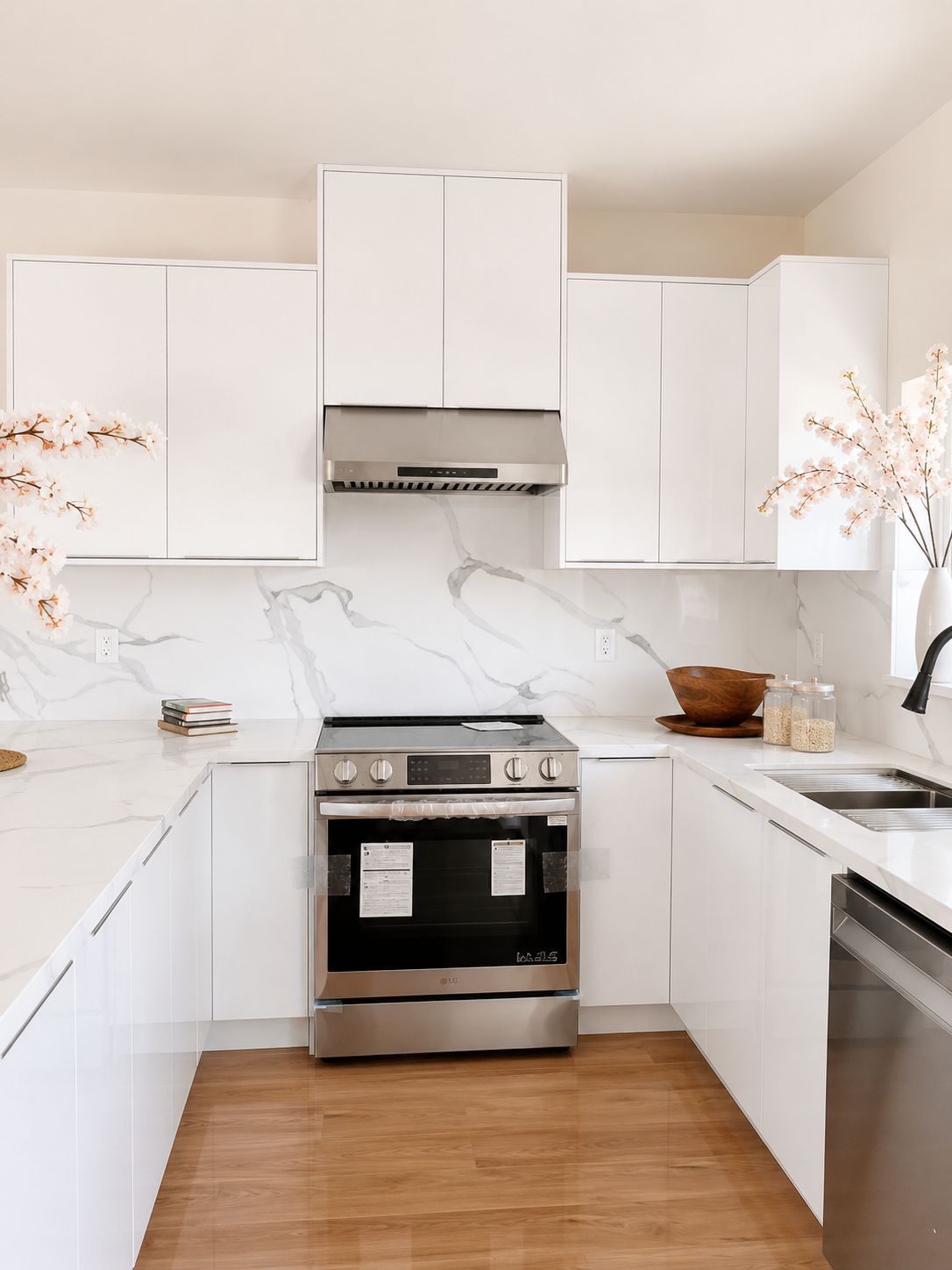 Kitchen range wall with marble slab backsplash and white cabinetry
