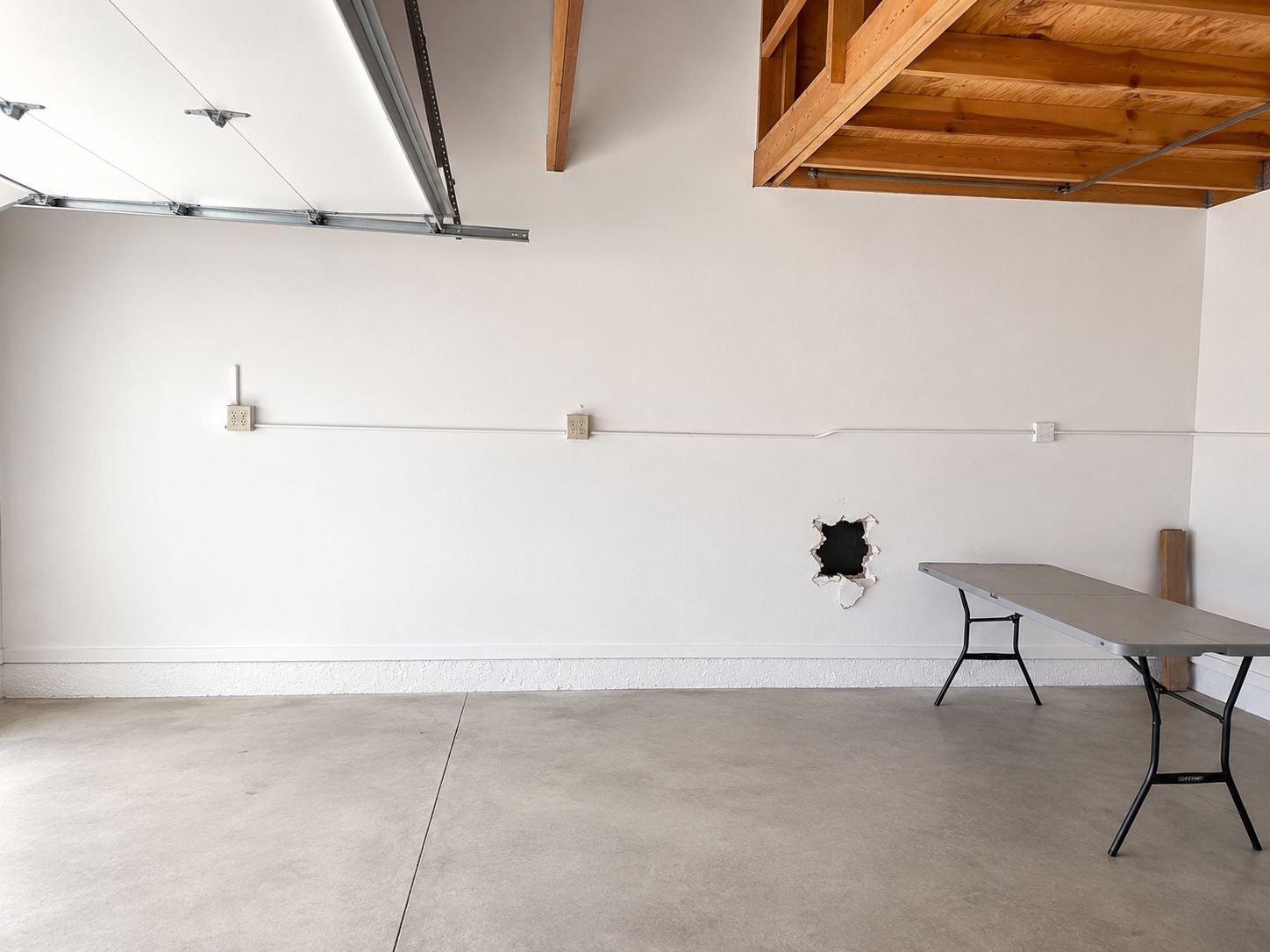 Garage interior before conversion with exposed framing